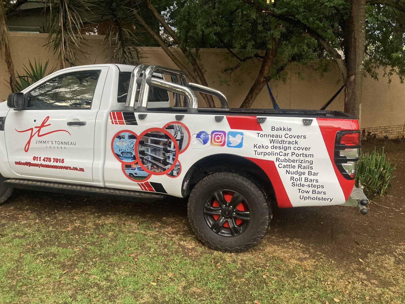 Commercial bakkie vinyl wrap with tonneau branding and contact details